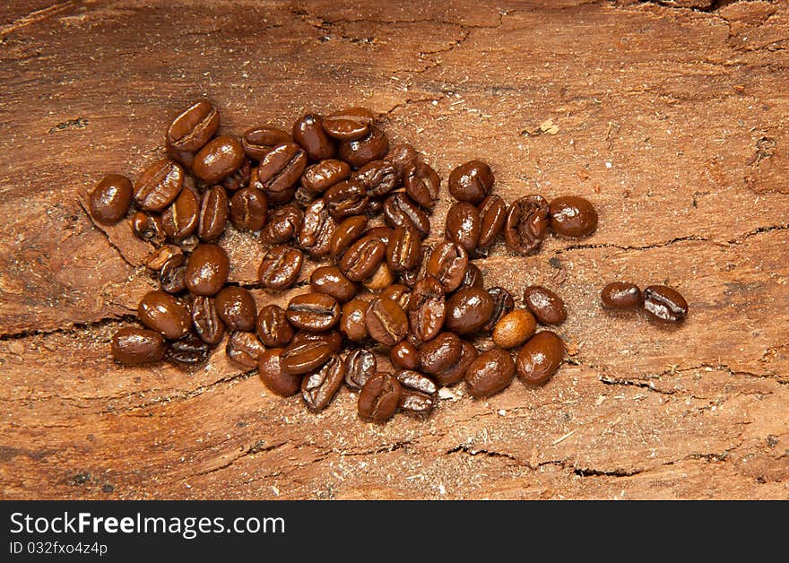 Fragrant fried coffee beans on the old wooden desk