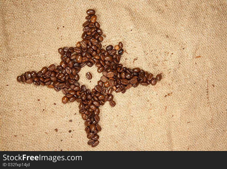 Fragrant fried coffee beans as the star on the jute. Fragrant fried coffee beans as the star on the jute