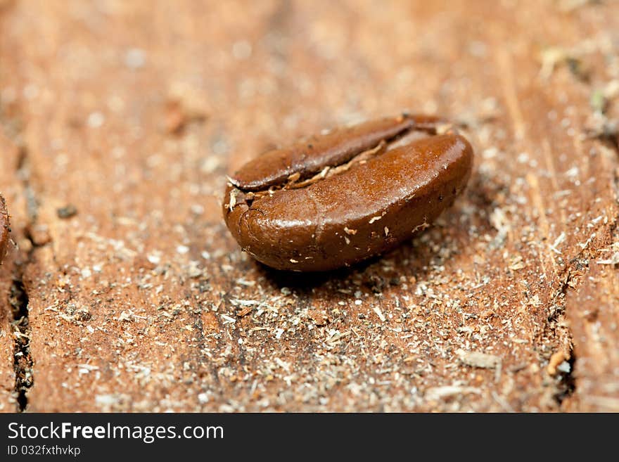 Macro coffee bean on the old wooden desk. Macro coffee bean on the old wooden desk