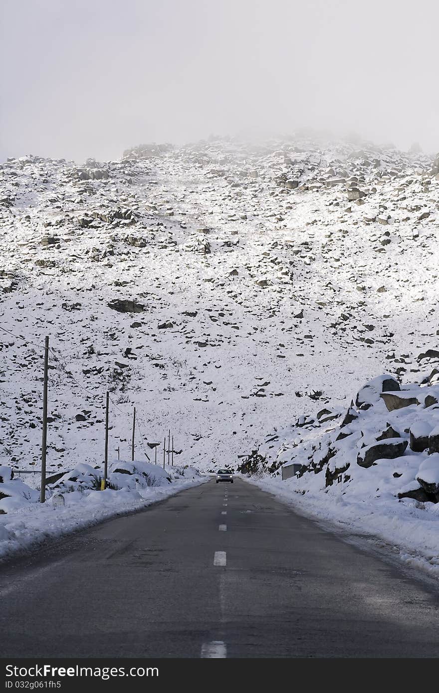 Car coming down from the mountain avoiding the storm. Car coming down from the mountain avoiding the storm