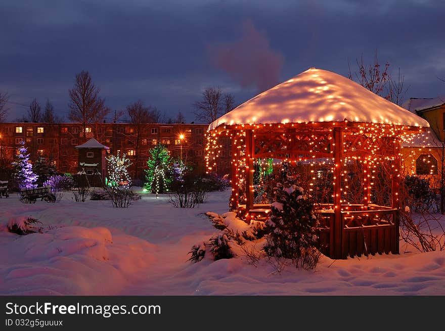 Park under snow with garlands decoration. Park under snow with garlands decoration