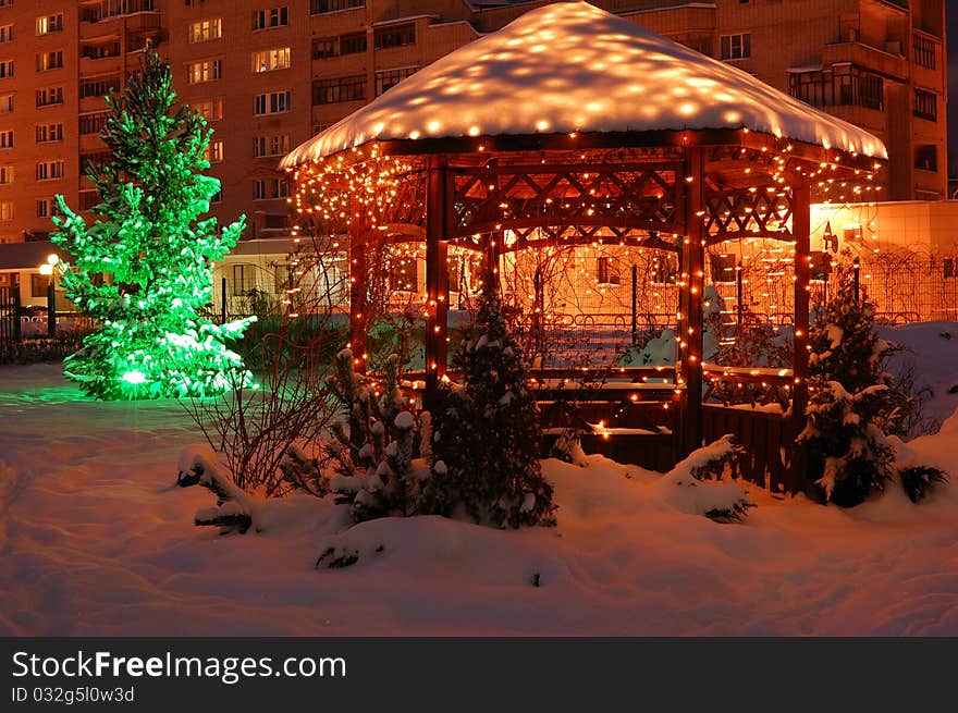 Park under snow with garlands decoration. Park under snow with garlands decoration