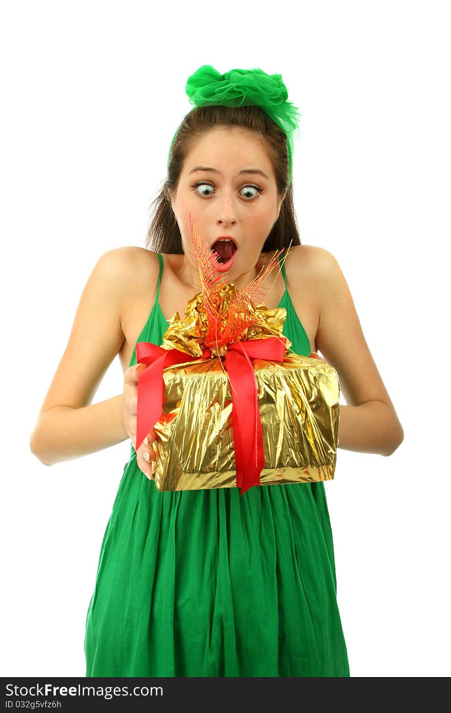 The young surprised girl holds a gift .isolated. The young surprised girl holds a gift .isolated