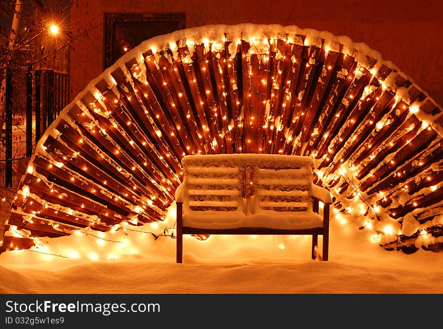 Wooden garden bench in Christmas Eve