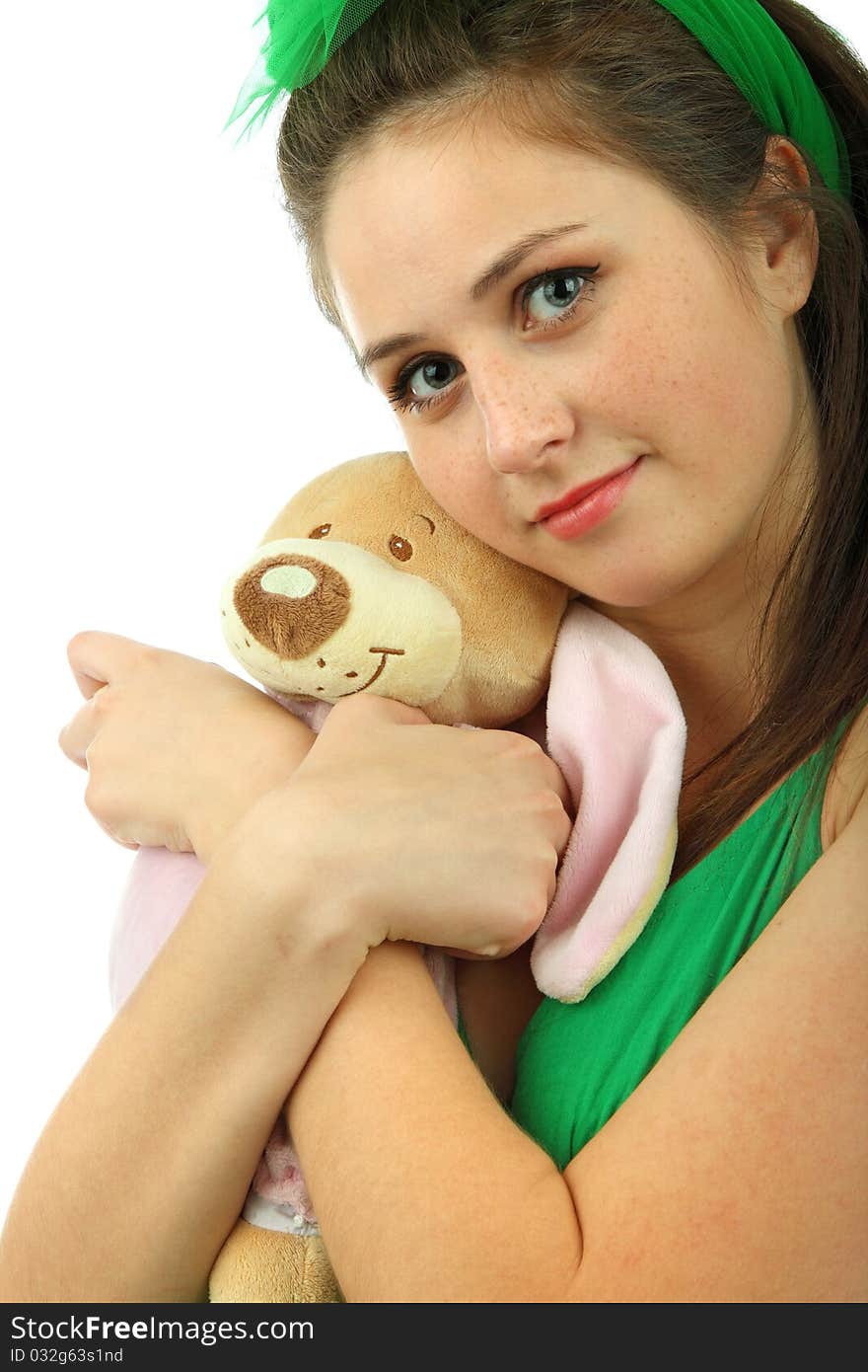 Portrait of the young girl with the teddy bear on a white background