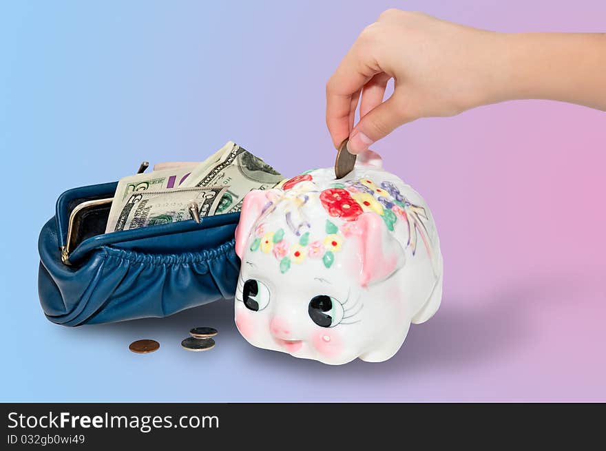 Female hand puts money into the  piggy  moneybox from purse  with dollars. Female hand puts money into the  piggy  moneybox from purse  with dollars