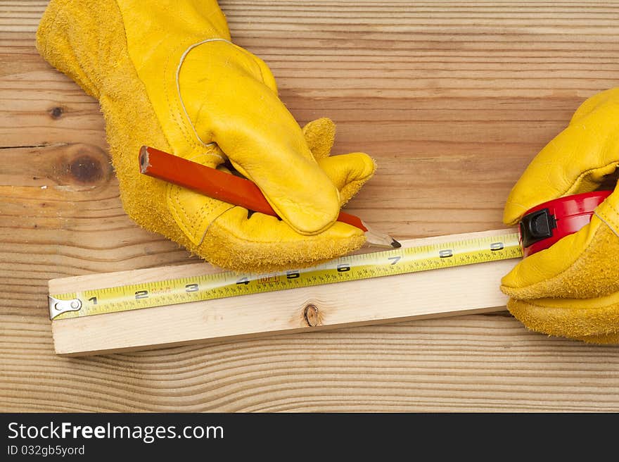 The worker makes a marking in meter