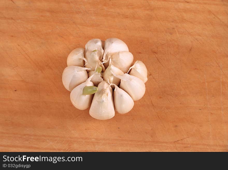 Over head garlic bulb image on wooden board