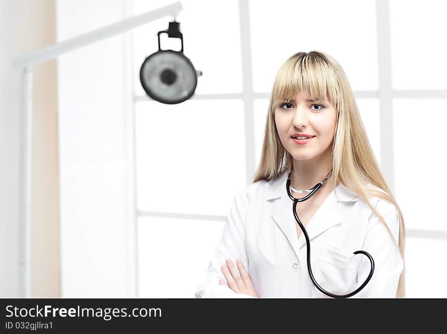 Woman doctor with blond hair in white. Woman doctor with blond hair in white