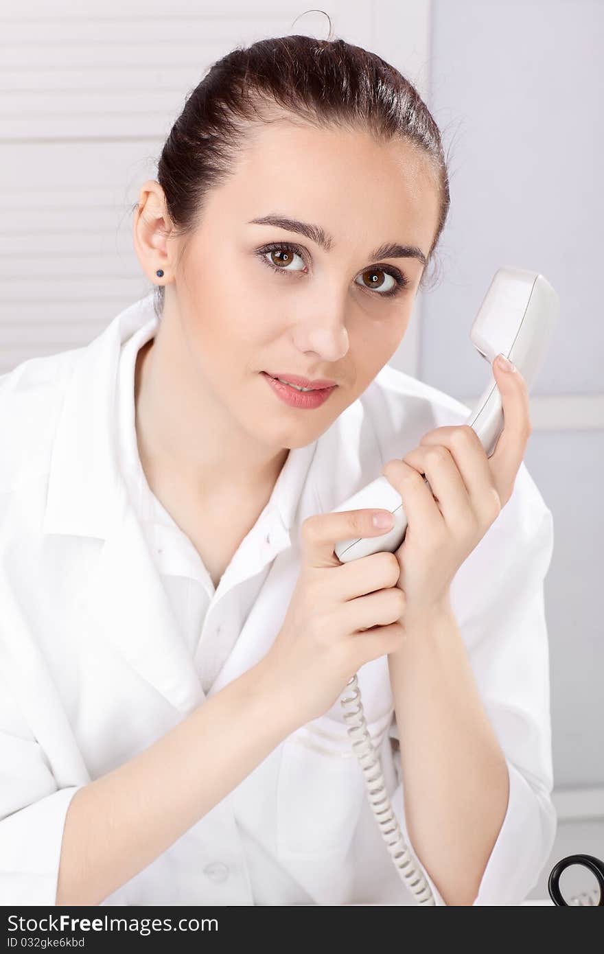 Female medical doctor working with a microscope. Female medical doctor working with a microscope