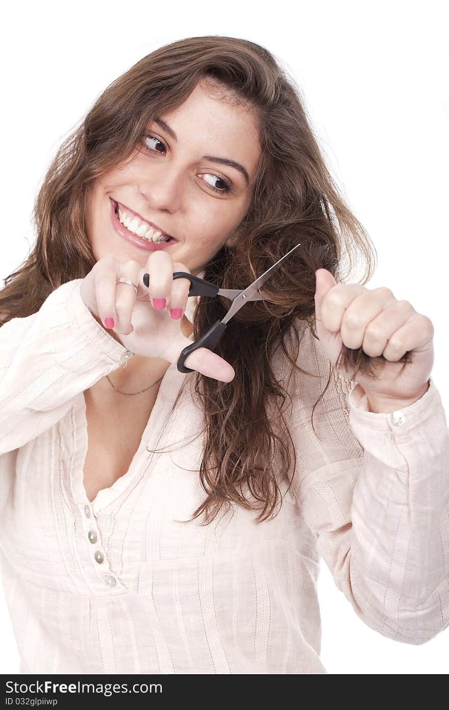 A young woman with a scissors trying to cut her hair. A young woman with a scissors trying to cut her hair