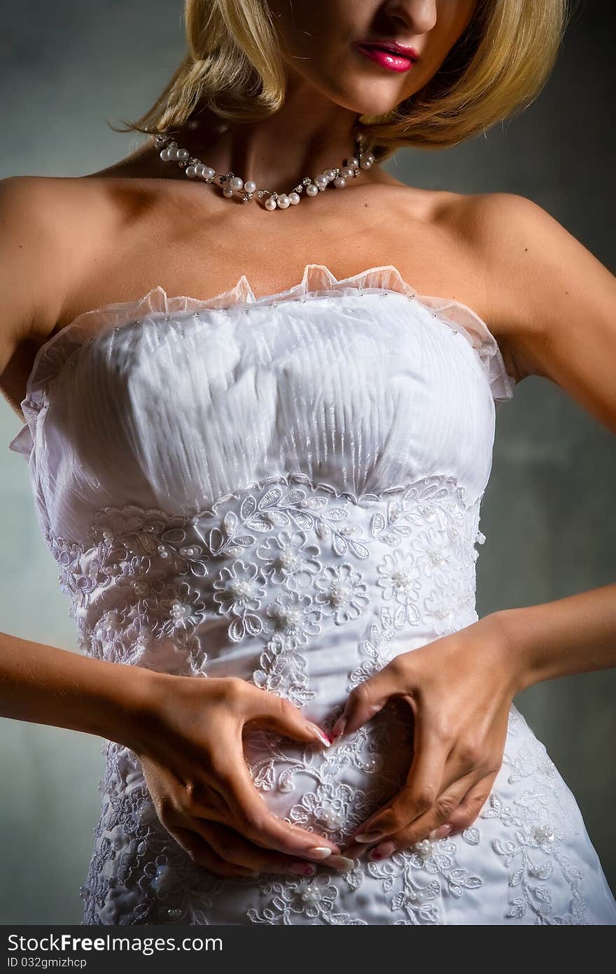 A woman's hands forming a heart symbol on belly. A woman's hands forming a heart symbol on belly