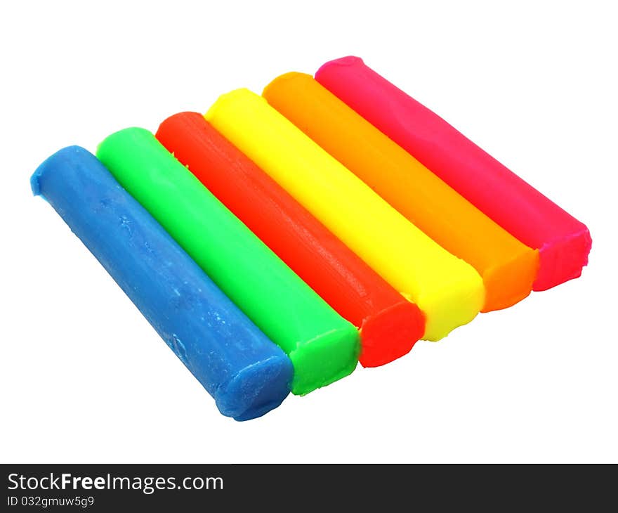 Color children's plasticine lies on a white background