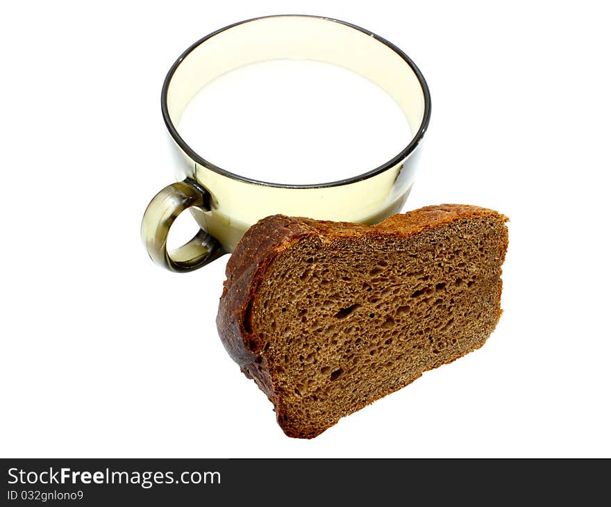 Black bread with milk in a mug on the white isolated background