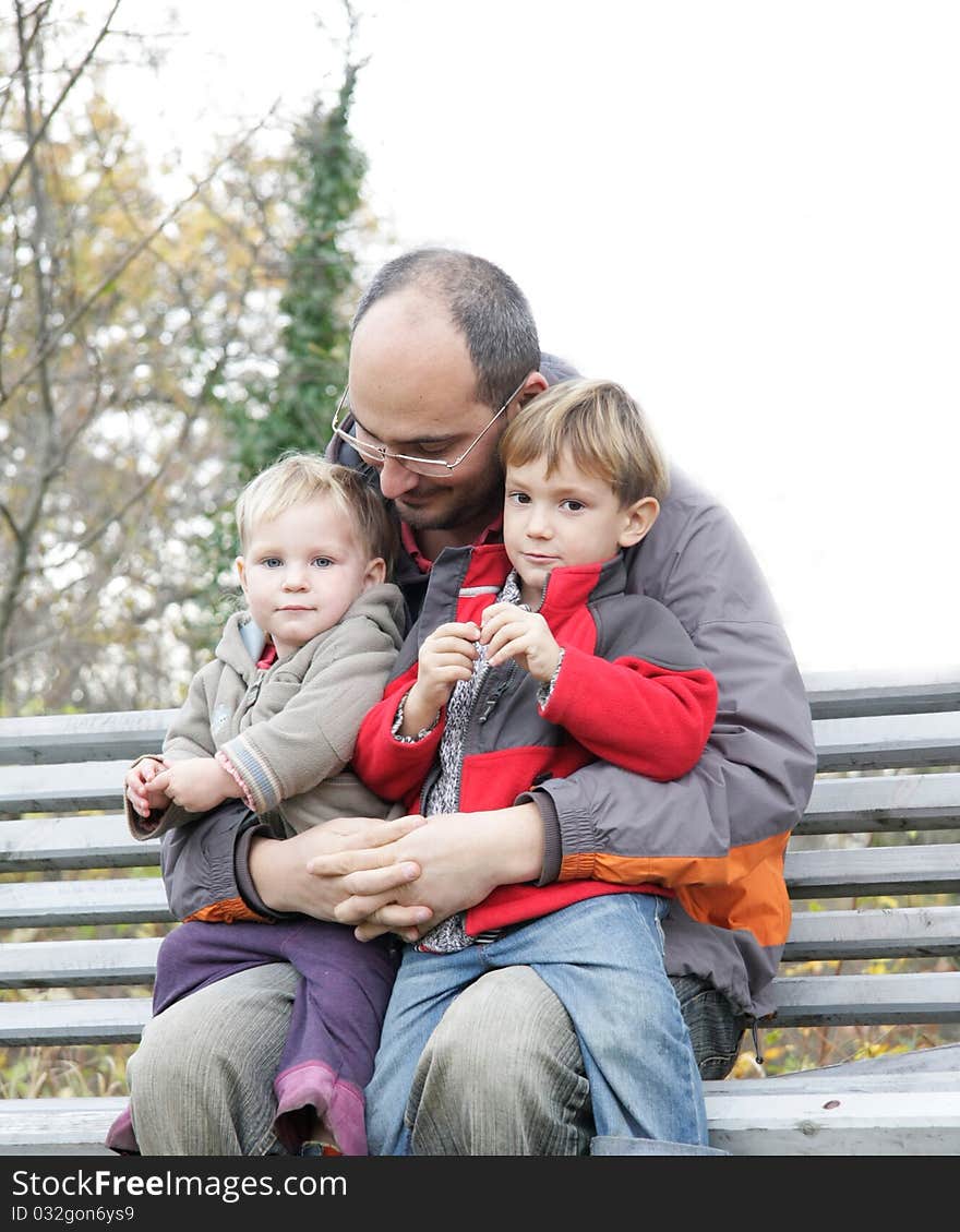 Father and two children outdoors