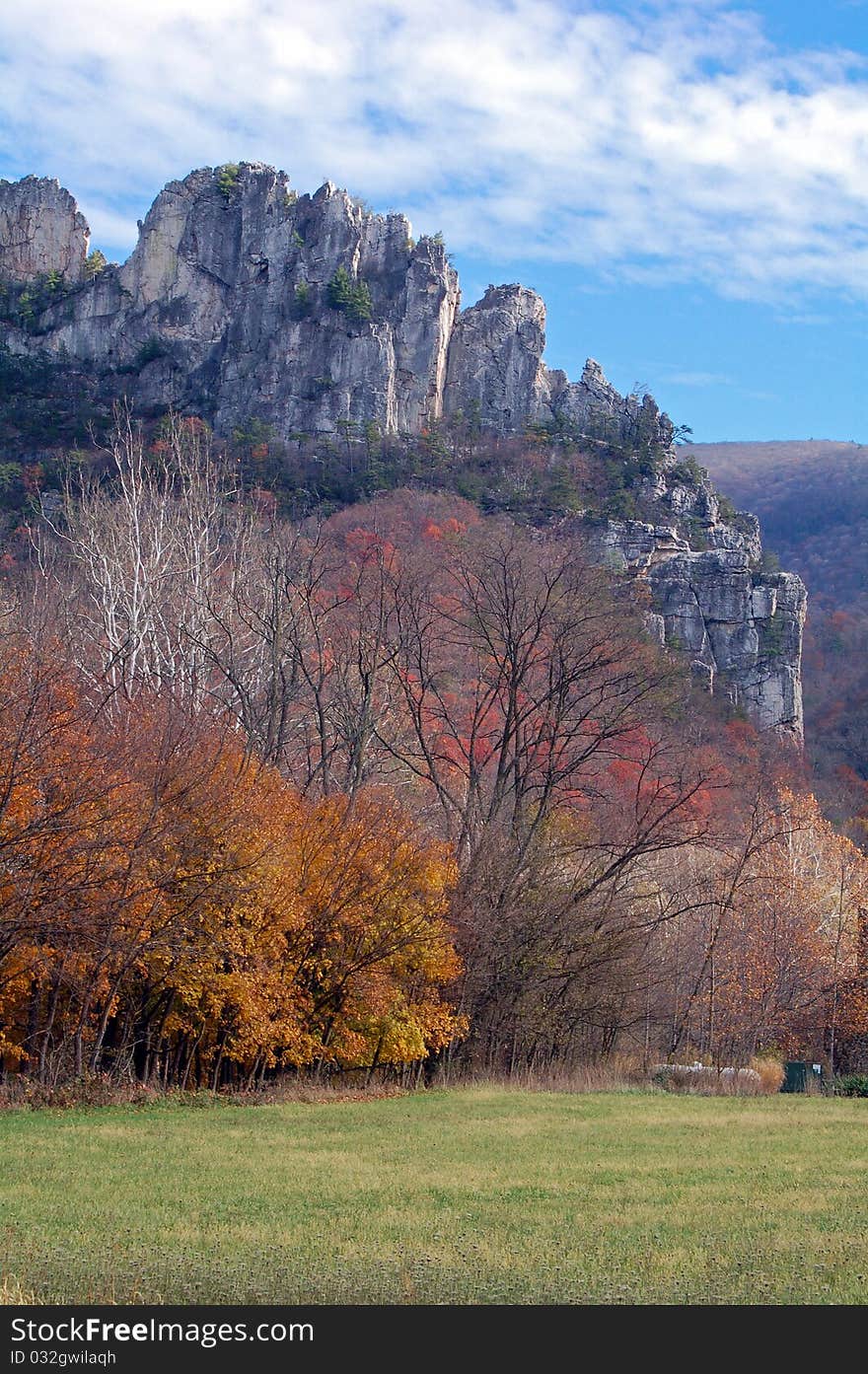 Fall foliage creates a lovely forefront for the jagged mountain to rest behind. Fall foliage creates a lovely forefront for the jagged mountain to rest behind.