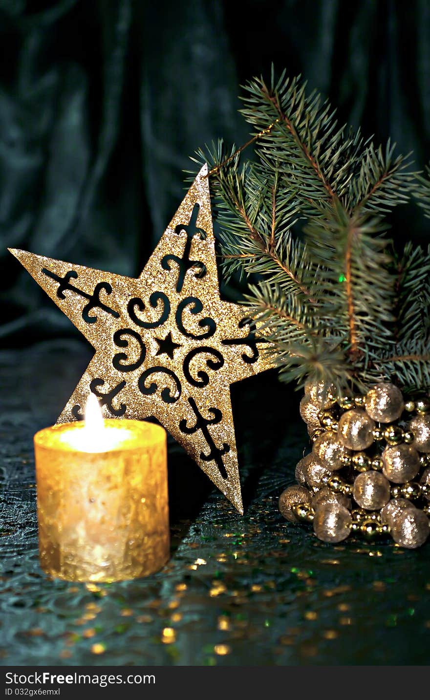 Christmas composition, candle, fir branch and star on a green background. Christmas composition, candle, fir branch and star on a green background.