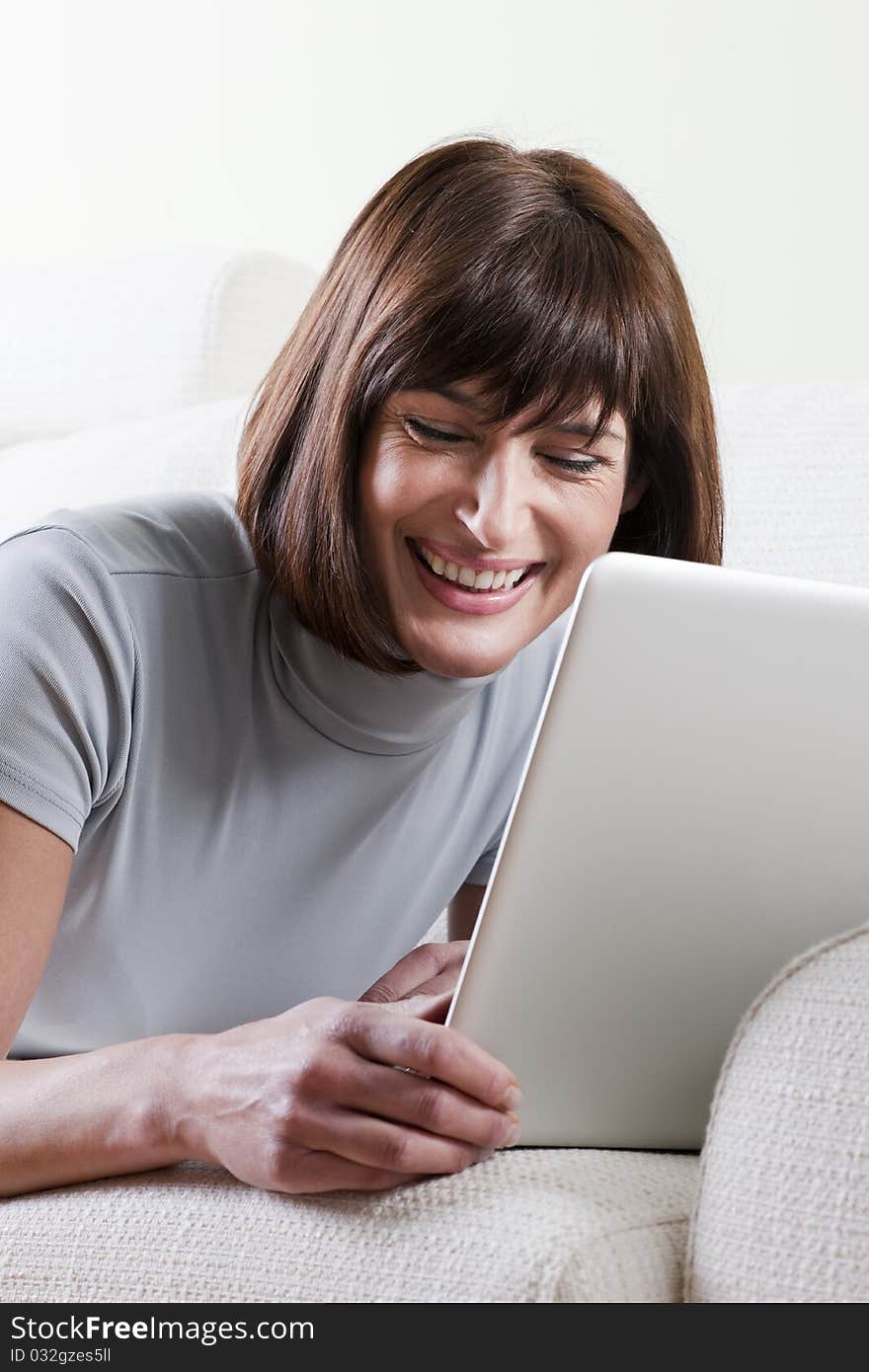 Woman using laptop at home. Woman using laptop at home