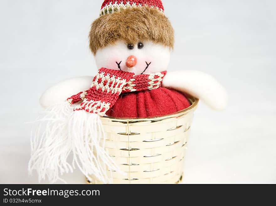 Snow man toy in a golden box decoration isolated