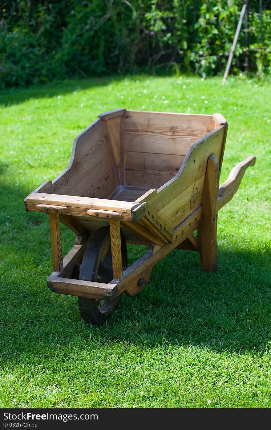 Wooden Trolley On Green Grass In The Garden