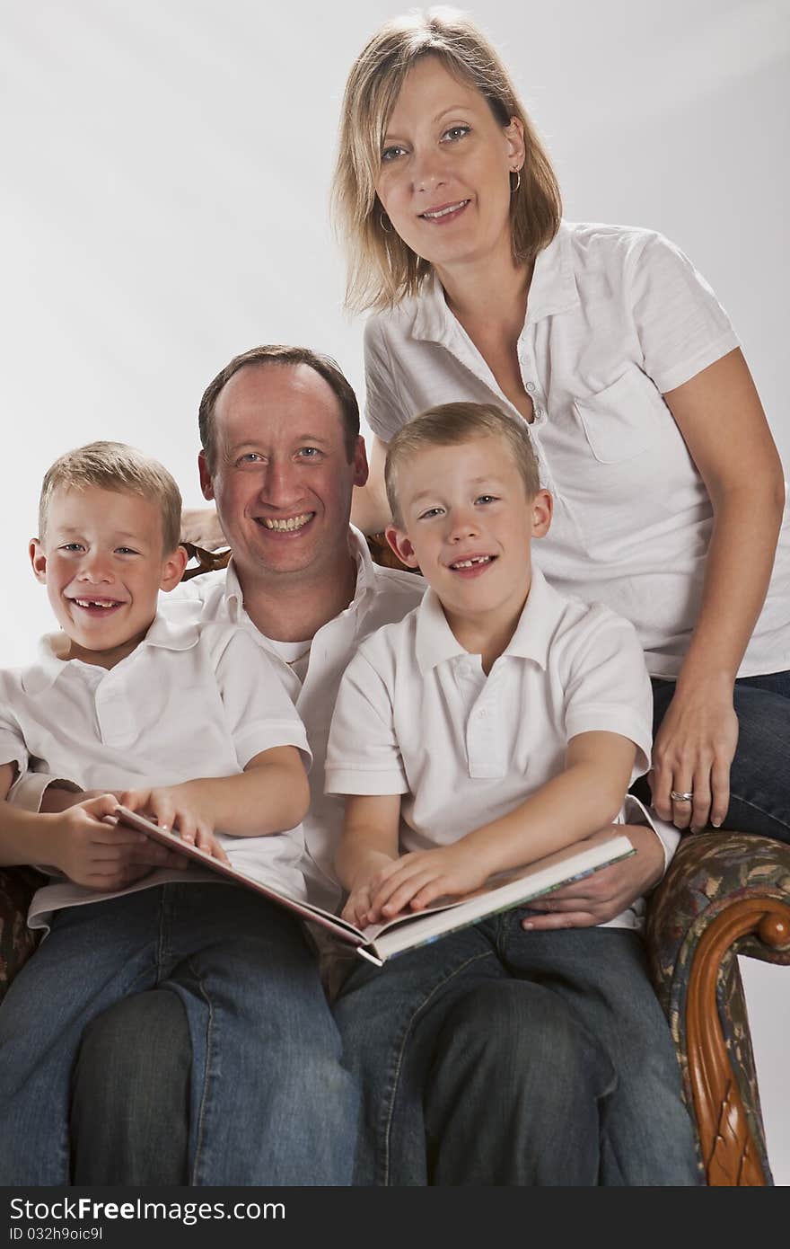 Modern family doing homework with 6 years old identical twins reading. Modern family doing homework with 6 years old identical twins reading