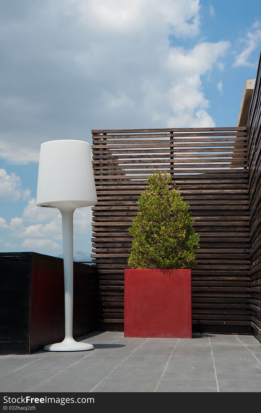 Floor lamp setting at a hotel roof under blue sky