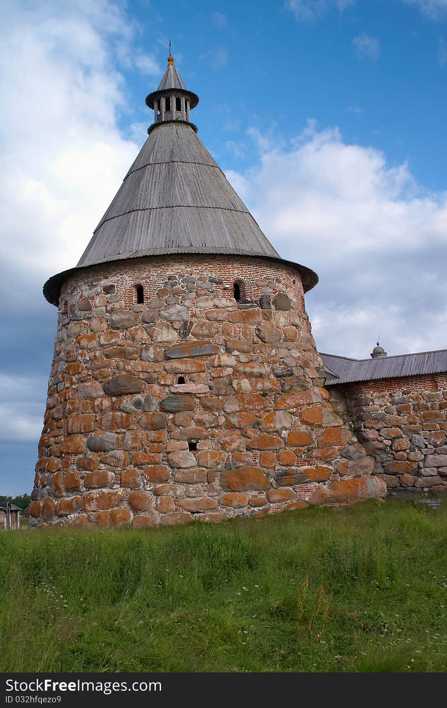 Old round stone tower in Solovetsky monastery with blue sky background, Karelia, Russian Federation. Old round stone tower in Solovetsky monastery with blue sky background, Karelia, Russian Federation.