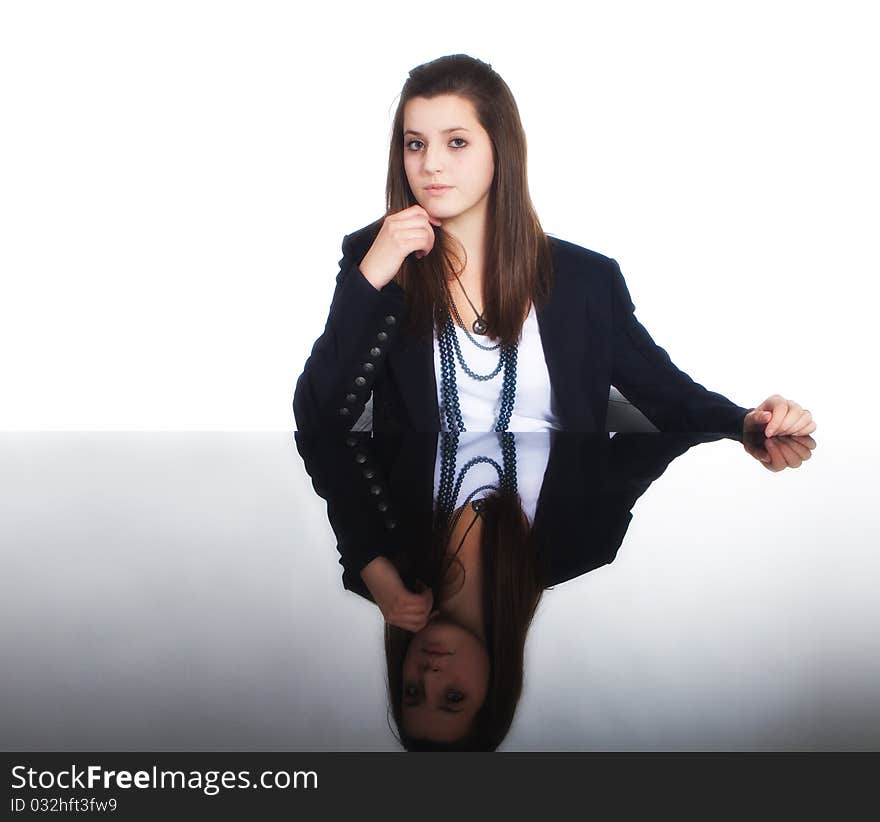 Young business teenage girl sitting at a mirror table. Young business teenage girl sitting at a mirror table.