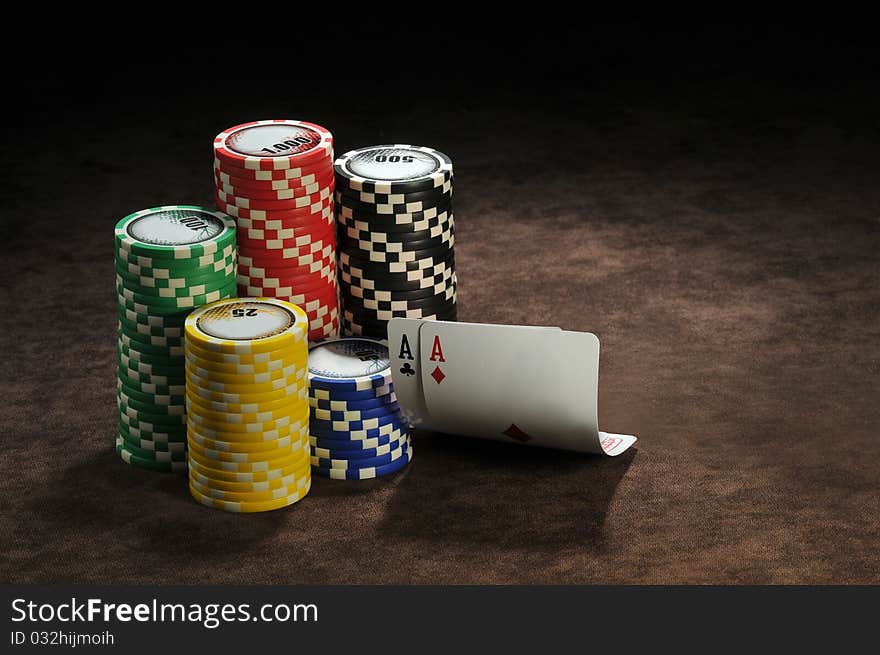 A pair of aces and chips in a table