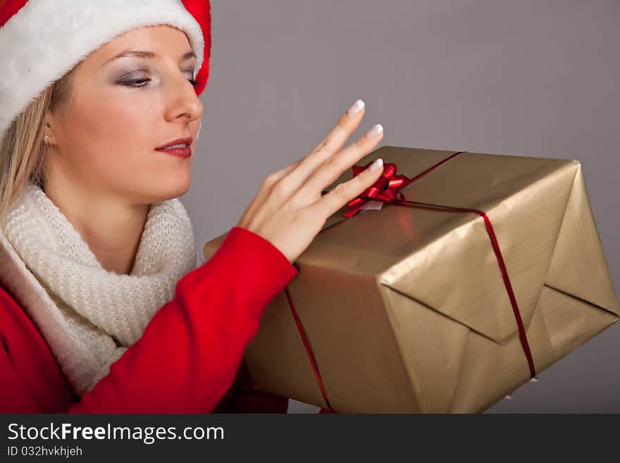 Woman in santa hat with christmas presents isolated on white background. Woman in santa hat with christmas presents isolated on white background