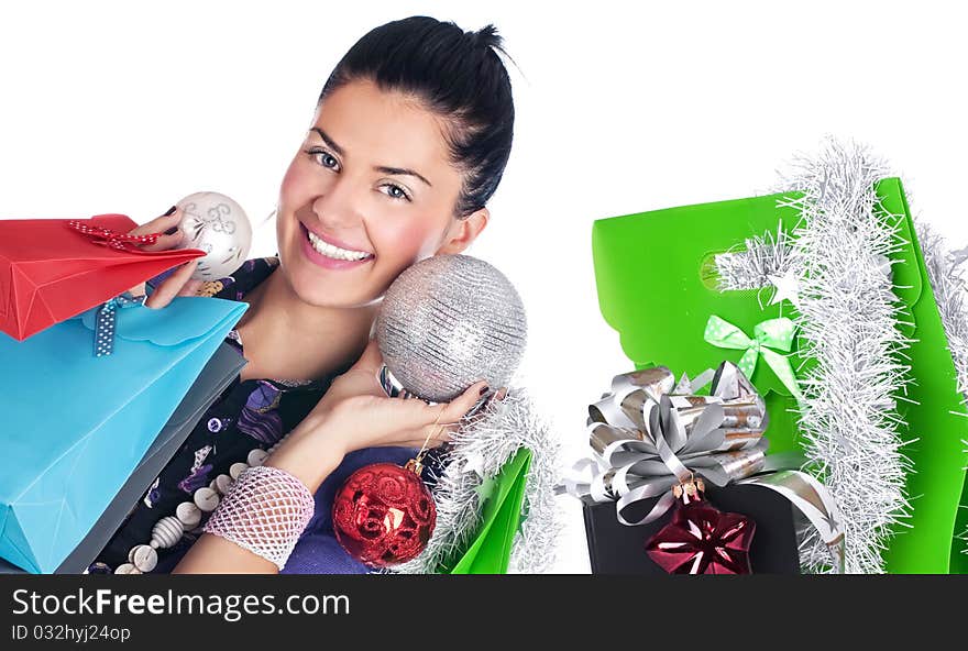 Happy girl with christmas decorations and bags, isolated. Happy girl with christmas decorations and bags, isolated