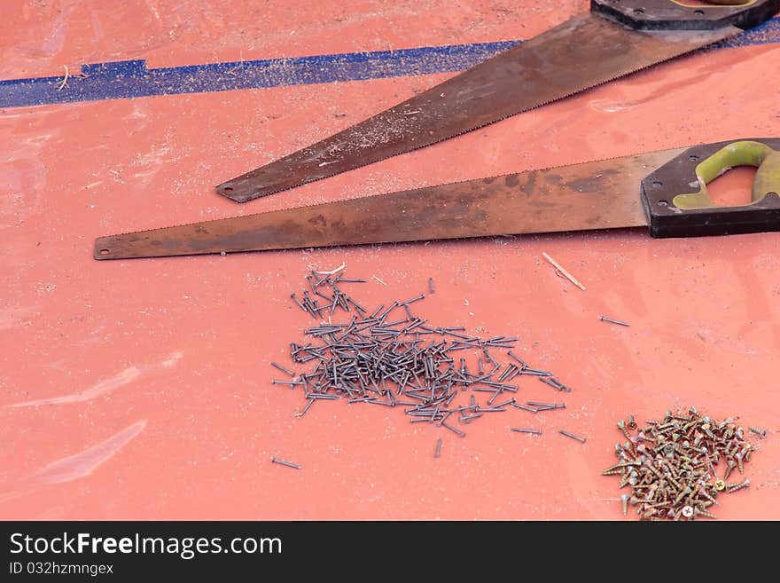 Saws nails and screws on a drop sheet. Saws nails and screws on a drop sheet