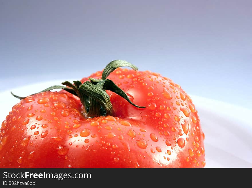 Juicy bright tomatoes on white plate. Juicy bright tomatoes on white plate