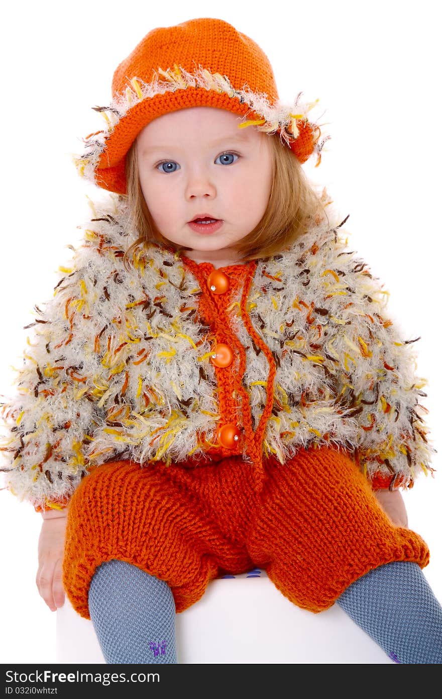 Little girl in orange hat smiling at camera on white background. Little girl in orange hat smiling at camera on white background