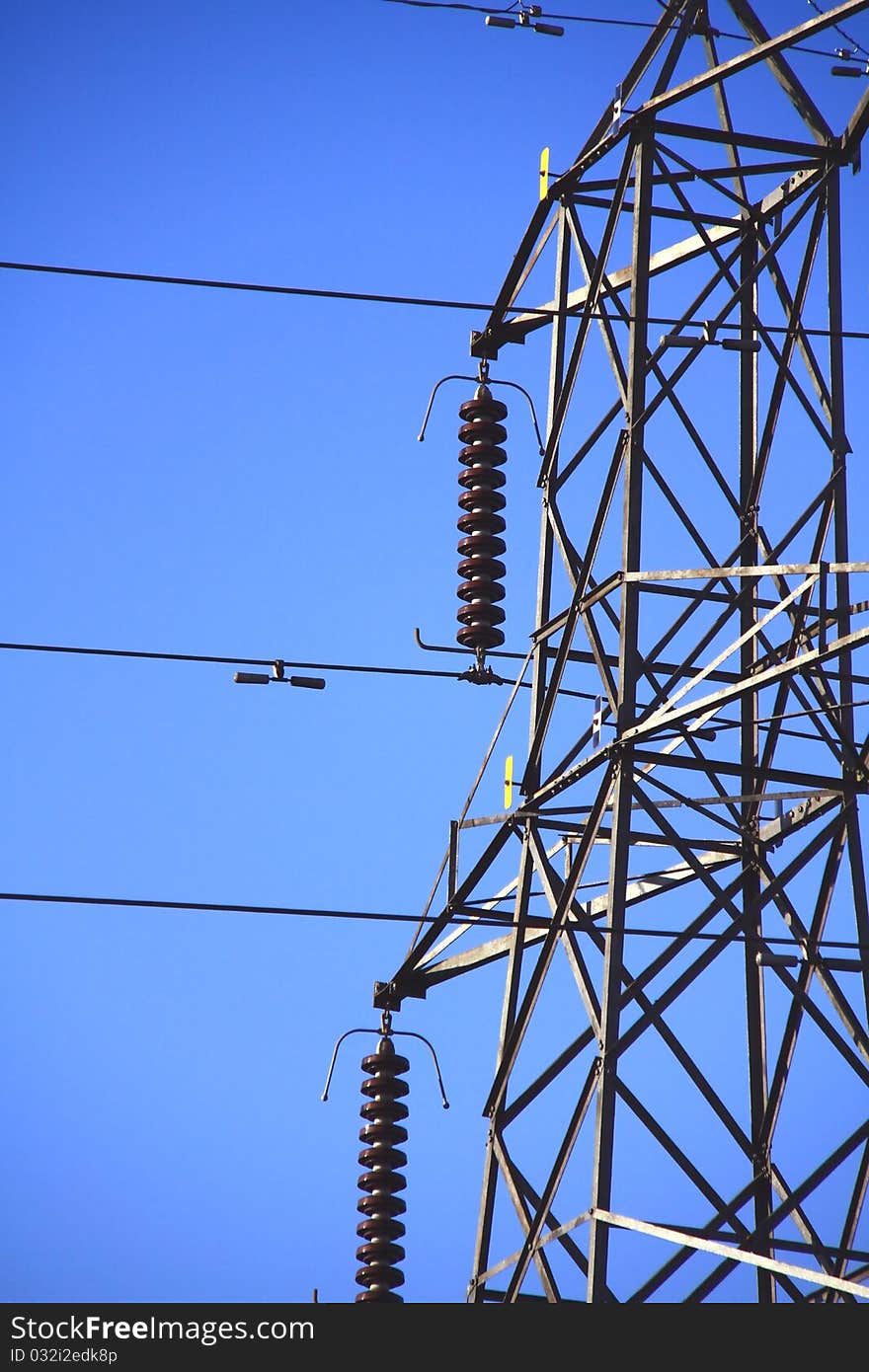 A close up picture of power lines with blue sky in the background. A close up picture of power lines with blue sky in the background