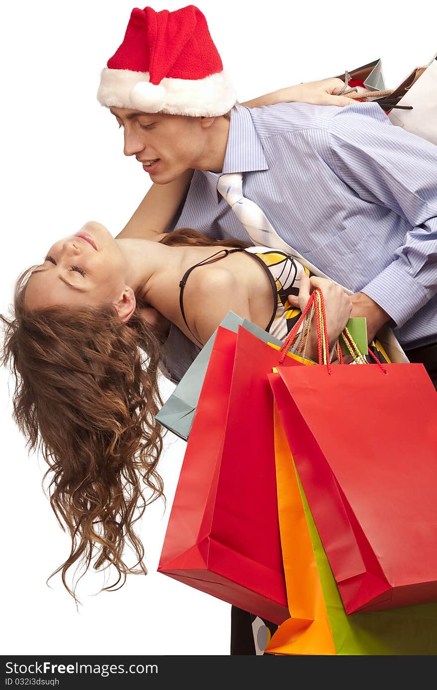 Lovely couple making christmas shopping. Isolated on white.