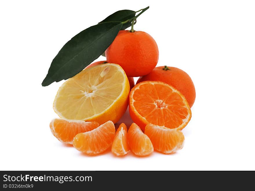 Tangerines and lemon with leaves on white background