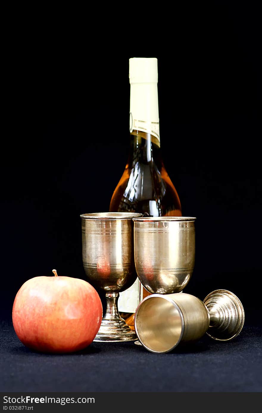 Wine glass and bottle on a black  background