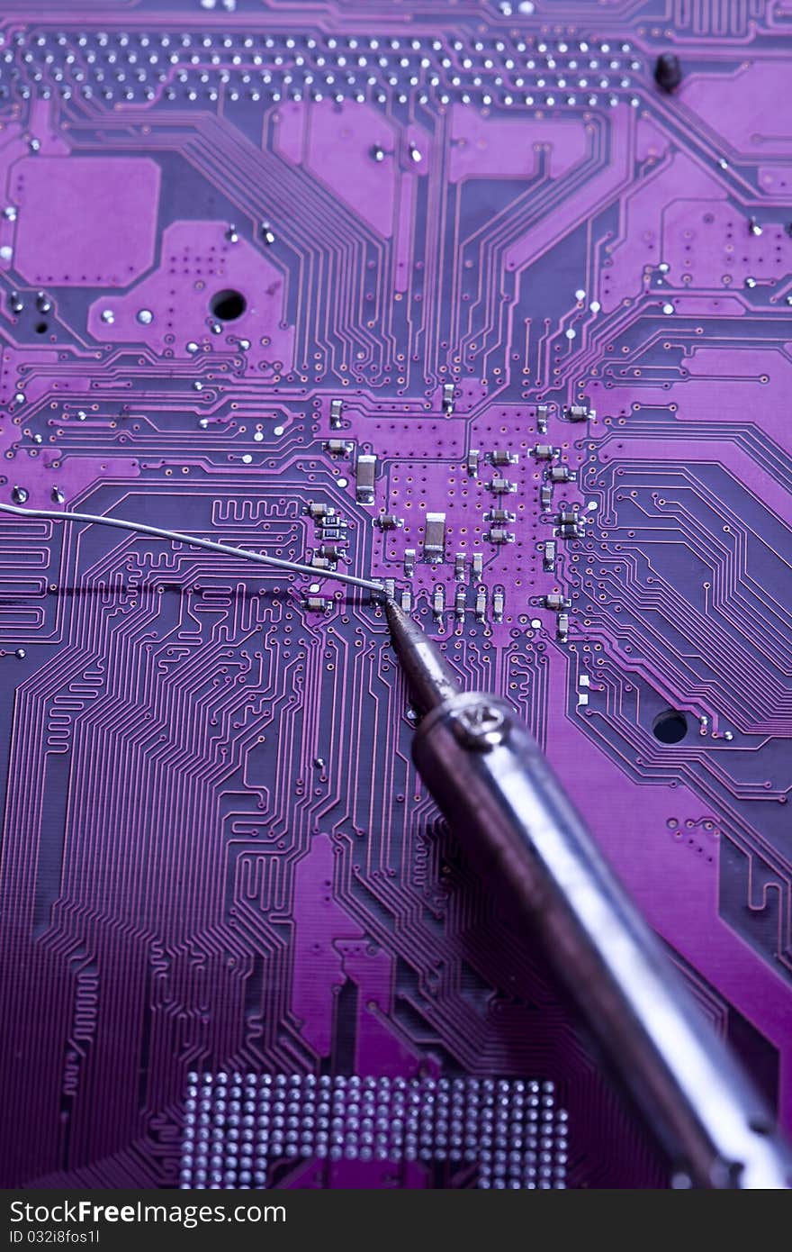 A close up shot of the backside of a computer circuit board, also known as a motherboard