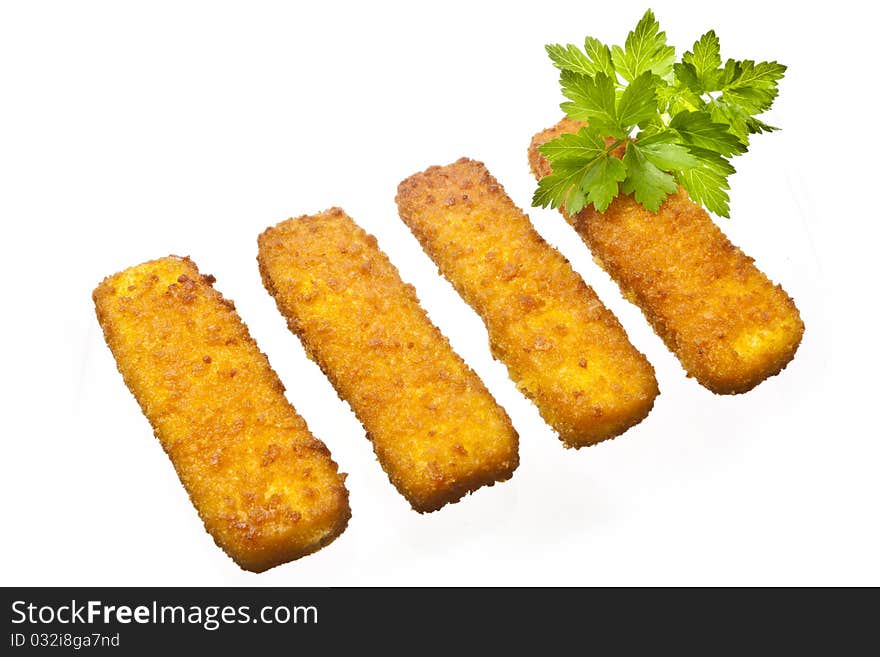 Four fish sticks isolated on white with some parsley