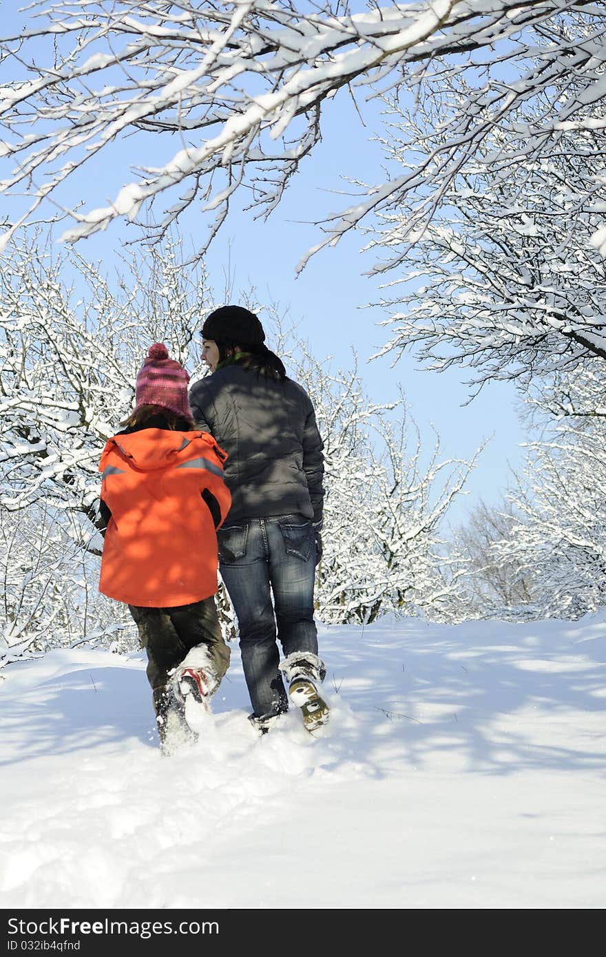 White mother and child relaxing outside in winter season. White mother and child relaxing outside in winter season