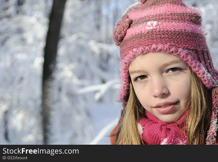 Funny girl posing in winter season, snow on branches in background. Funny girl posing in winter season, snow on branches in background