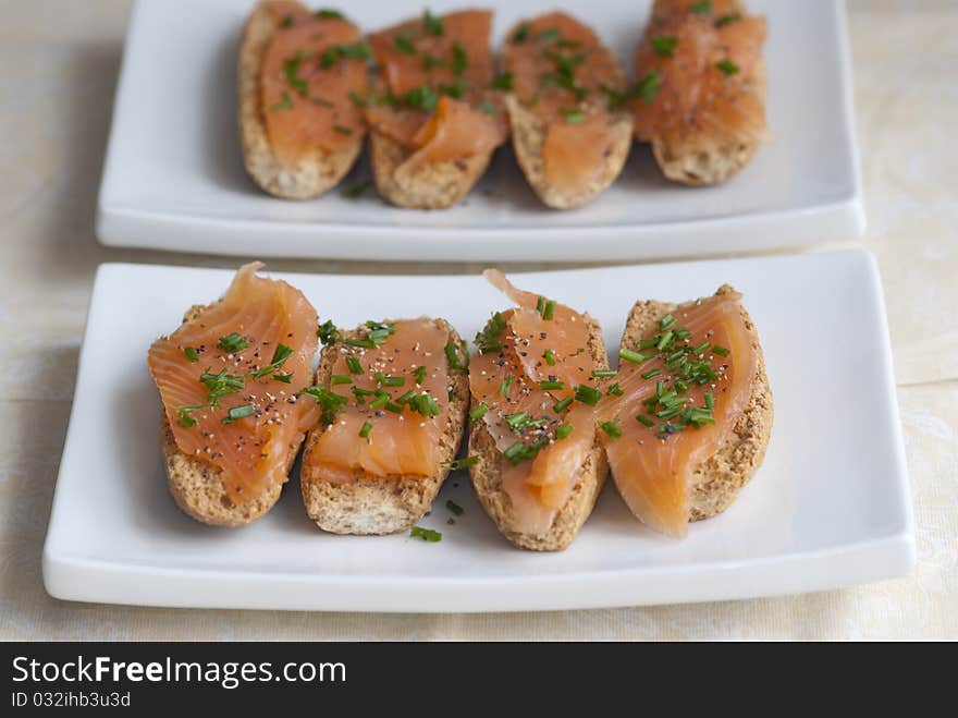 Swedish crisp bread topped with smoked salmon and chives. Swedish crisp bread topped with smoked salmon and chives