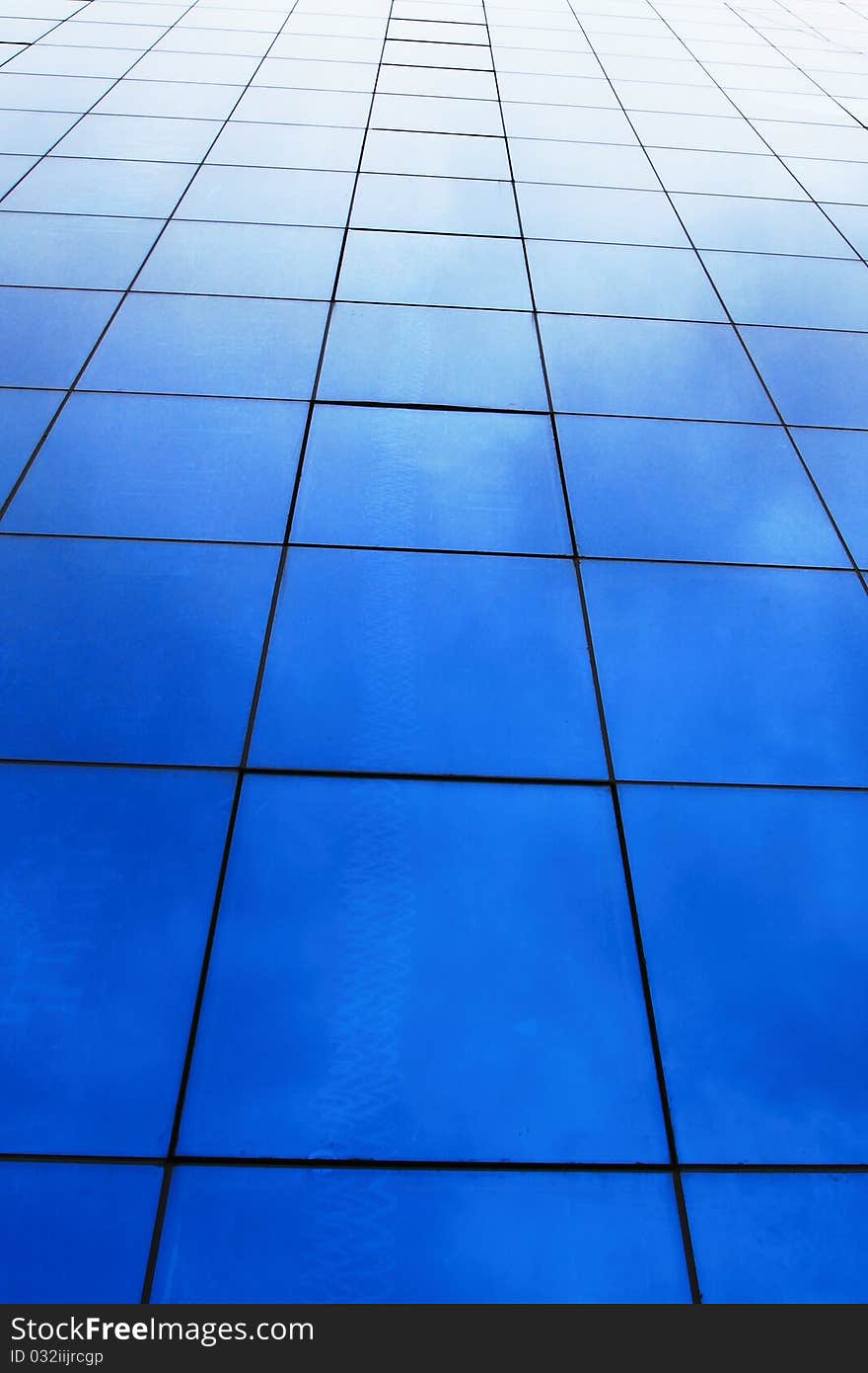 Modern office building and blue sky reflection