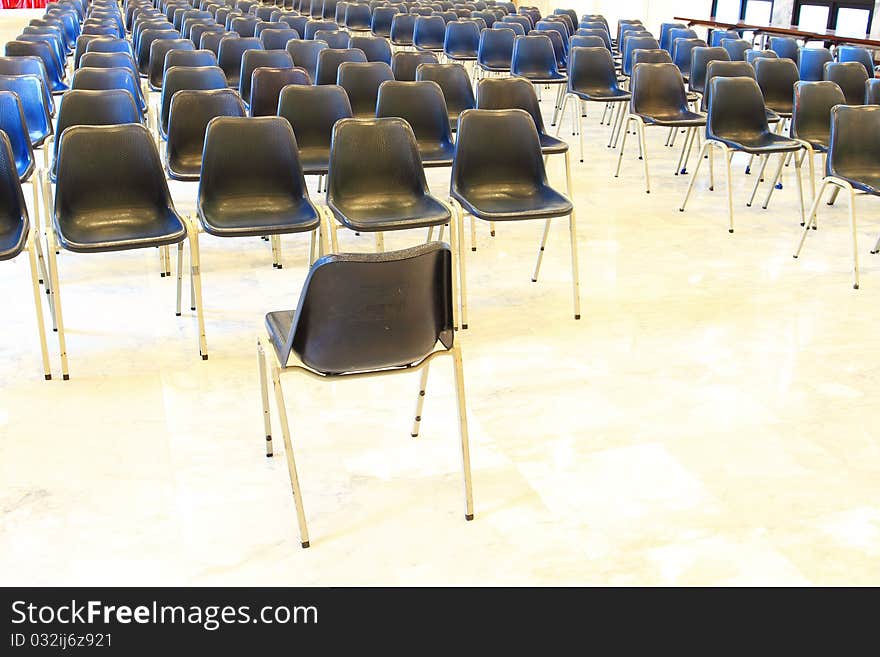 Black chairs in meeting room arranged for meeting