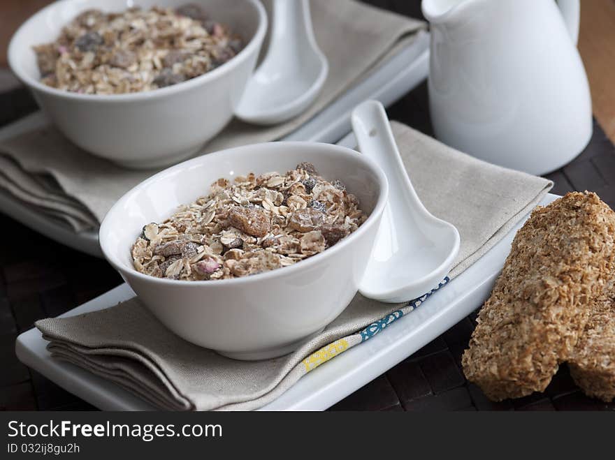 Muesli with raisins in a bowl with milk