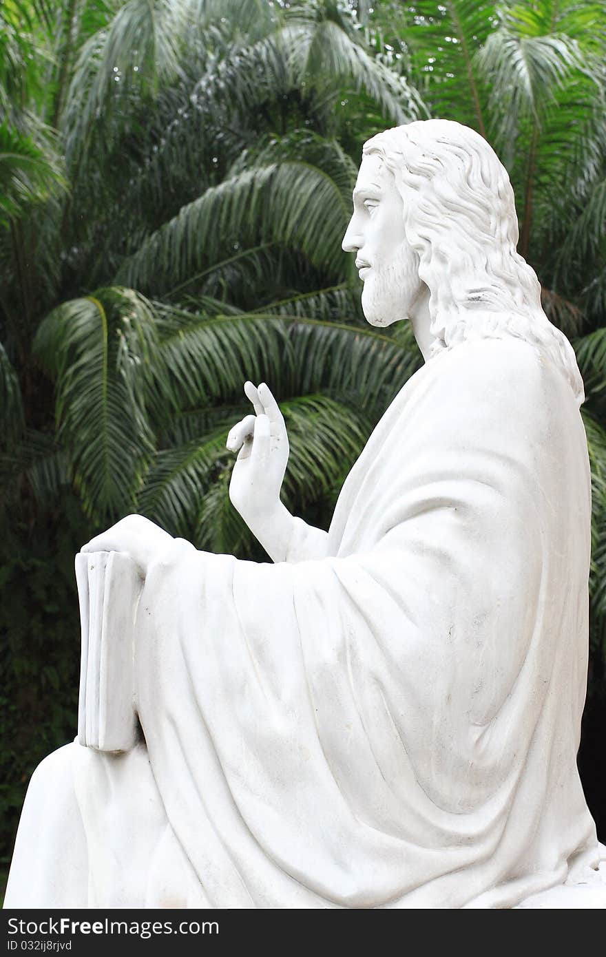 White Jesus statue in front of church