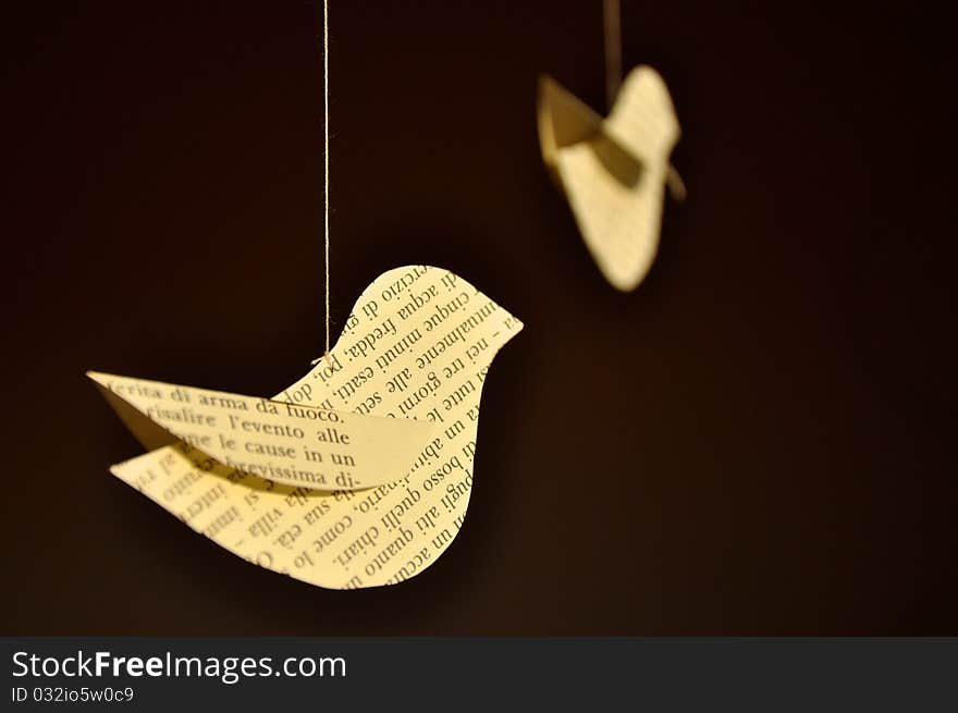 Decorative paper birds in front of a window