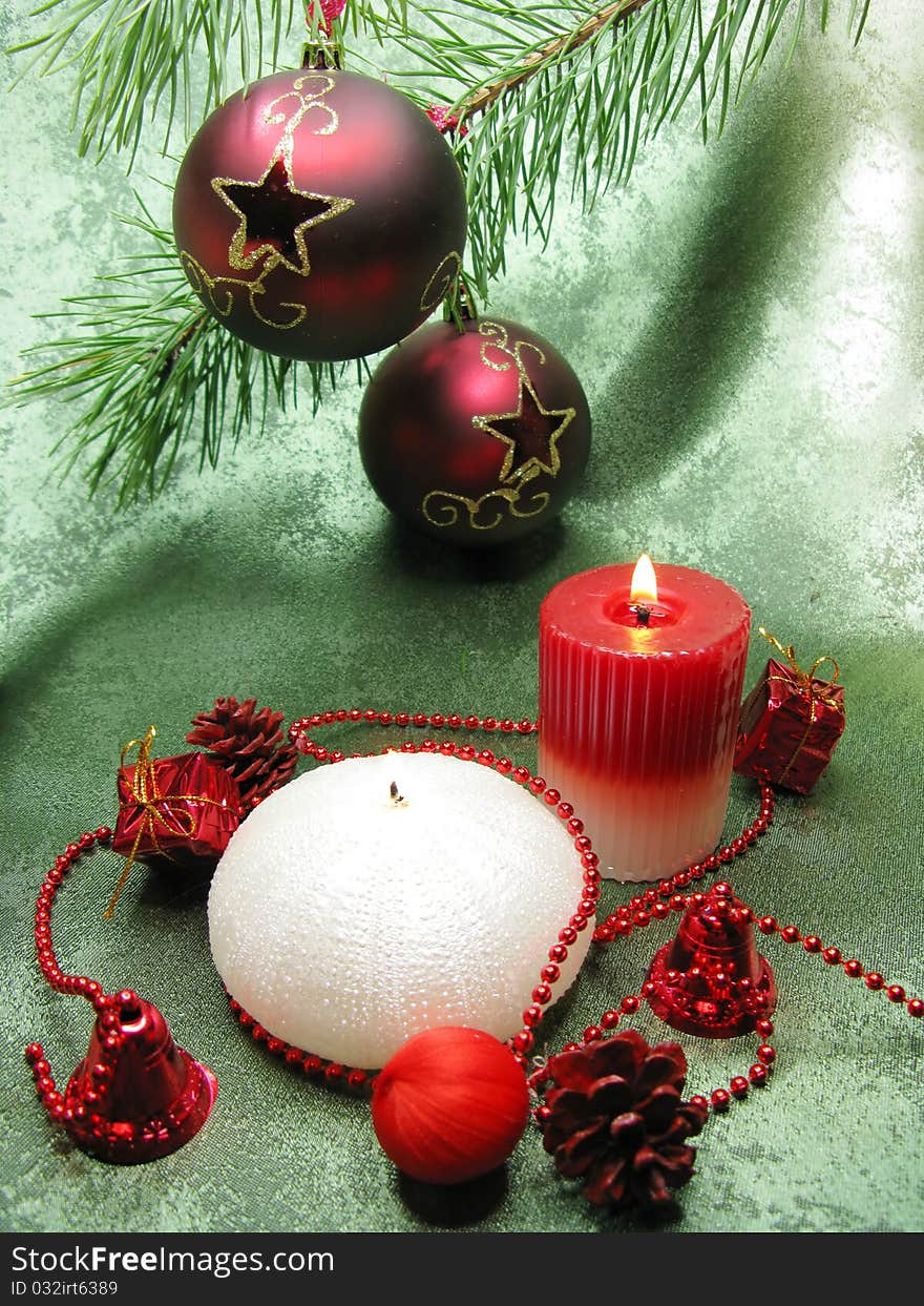 Two red ornamented with gold stars christmas balls scented candles on green background. Two red ornamented with gold stars christmas balls scented candles on green background