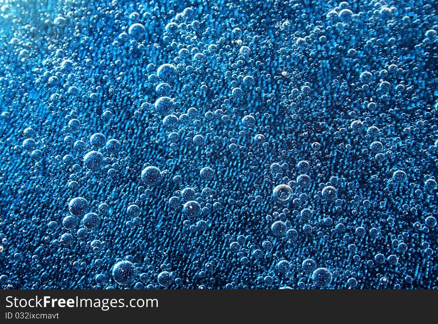 A series of bubbles under blue water. A series of bubbles under blue water